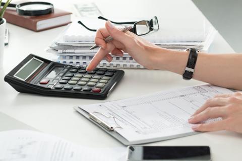 PHOTO: Thinkstock.com. Close up of female accountant making calculations